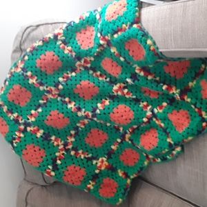 Granny Square Afghan green and orange afghan mixed with yellow, red and blue.